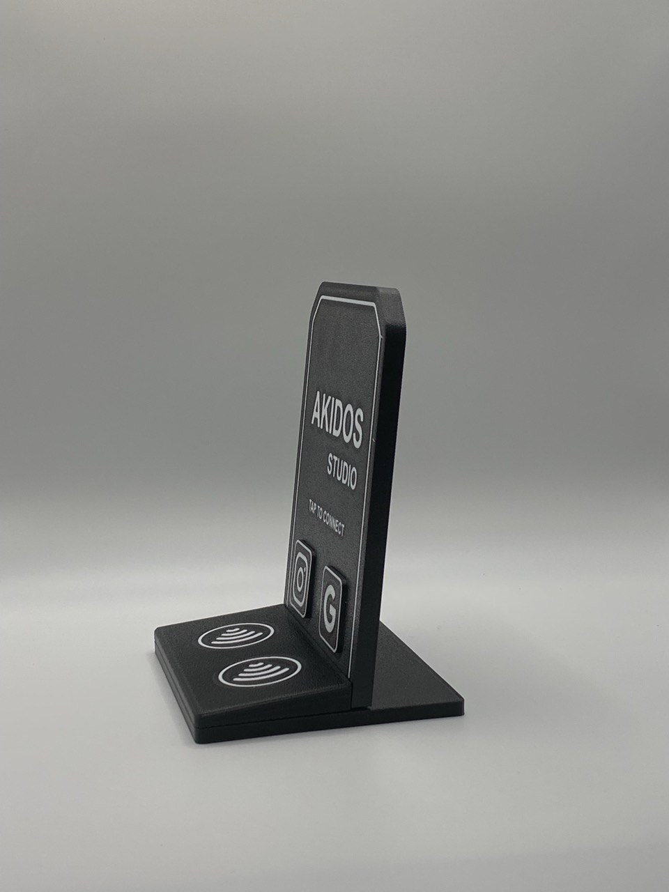 Printed Akidos Studio NFC stand viewed at an angle